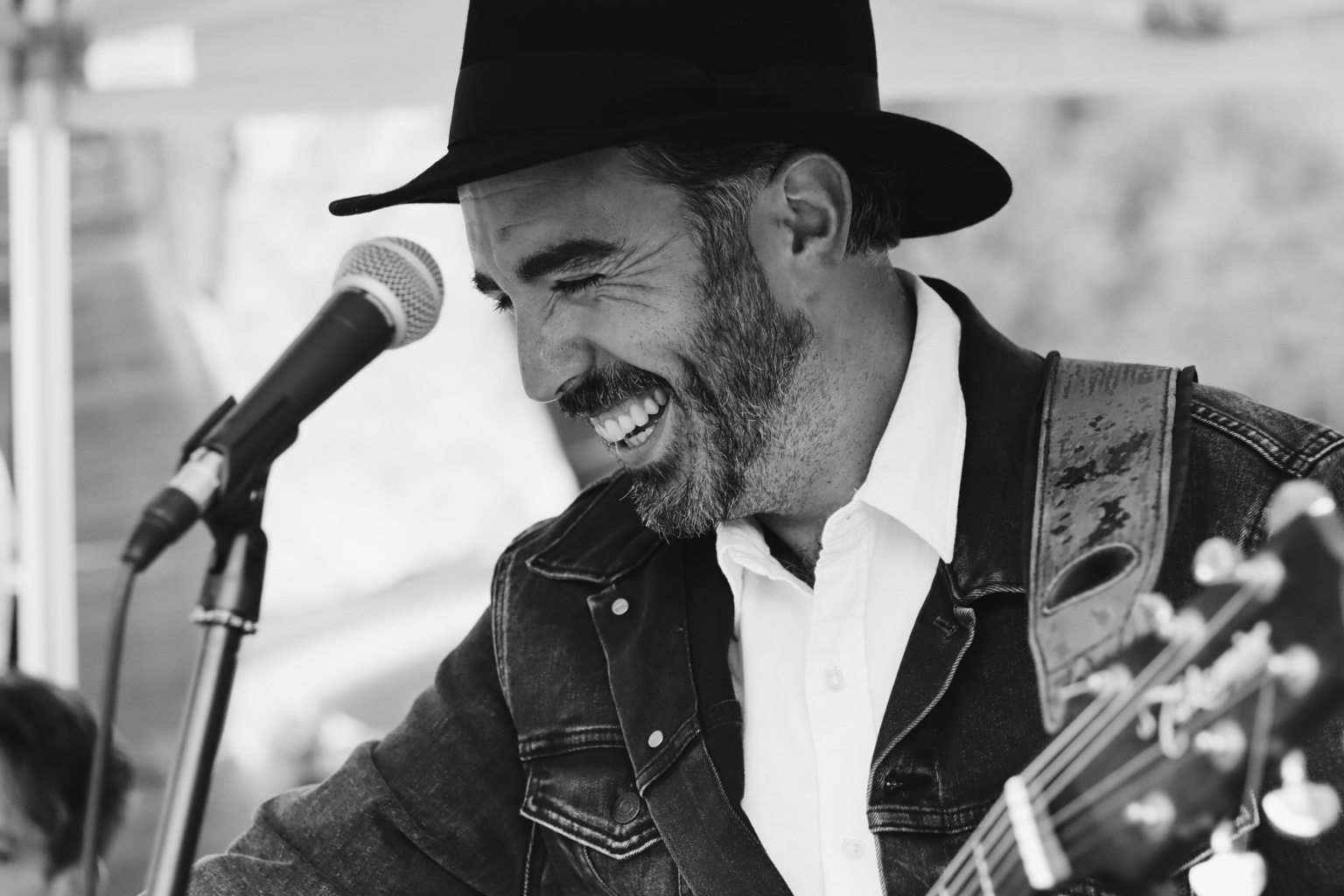 Matthew Quinn performing with guitar and microphone
